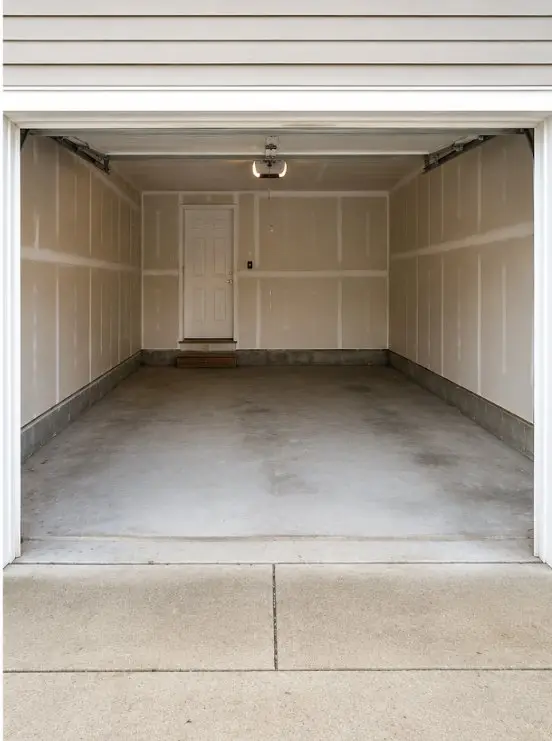 Empty garage swept clean after a junk removal clean-out