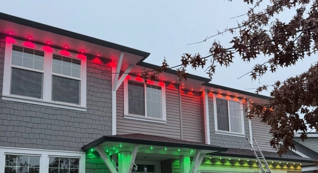 The same home lit with red and green Govee lights along the rooflines