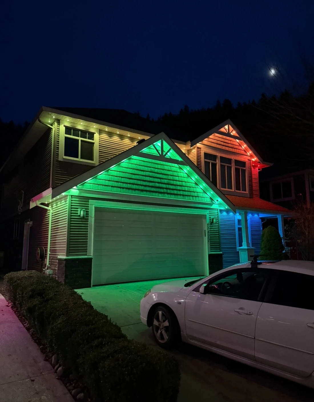 Gabled home at dusk lit with warm white Govee permanent lights along the roofline