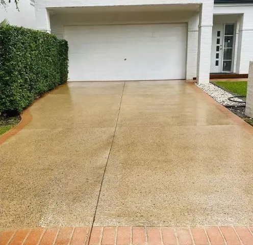 The same driveway bright and clean after pressure washing