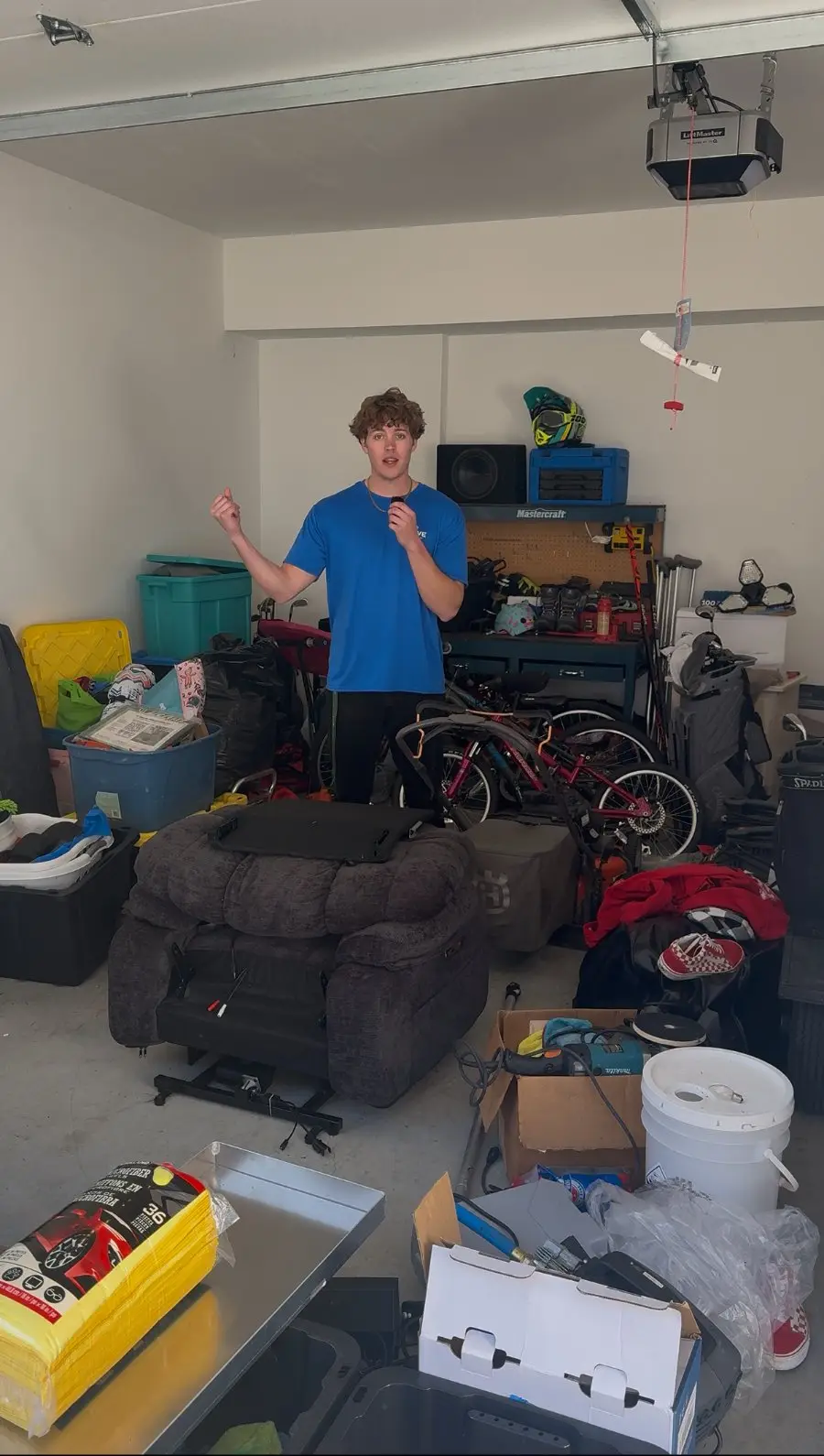 Crew member in a cluttered garage ready for a clean-out