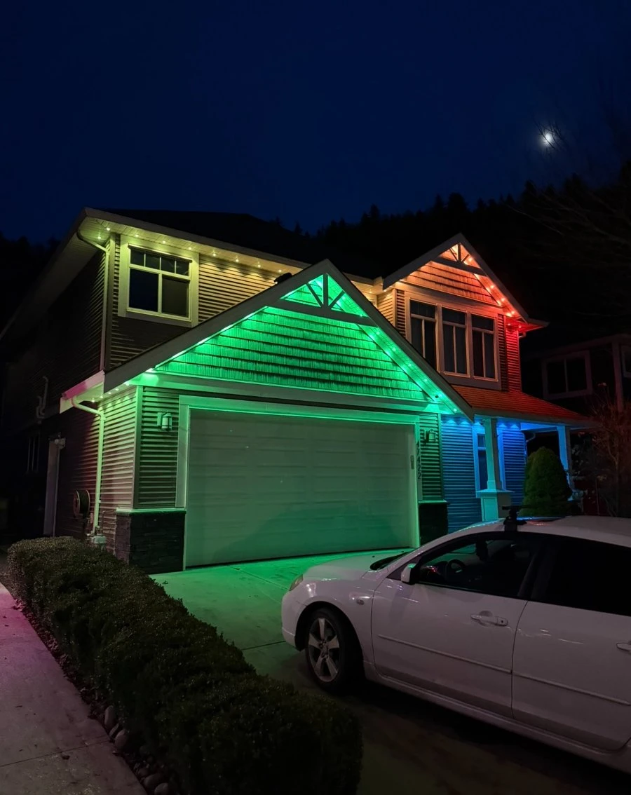 Home lit with green and blue permanent LED roofline lights