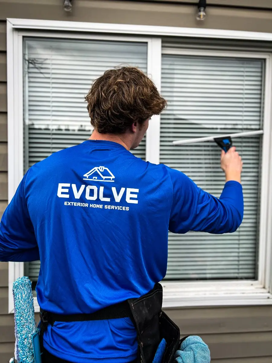 Crew member squeegeeing a window