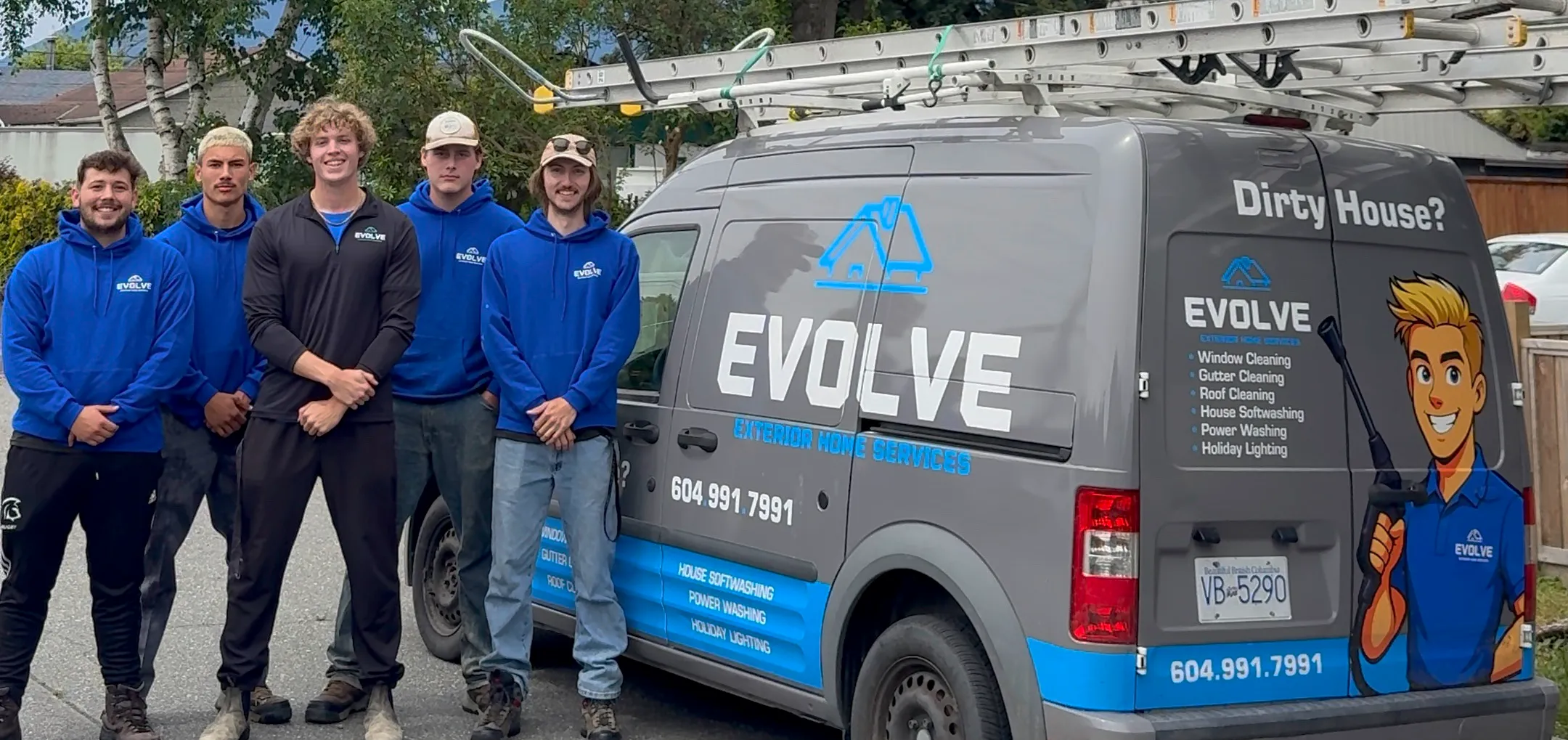 The Evolve Exterior Home Services crew standing beside the branded Evolve van