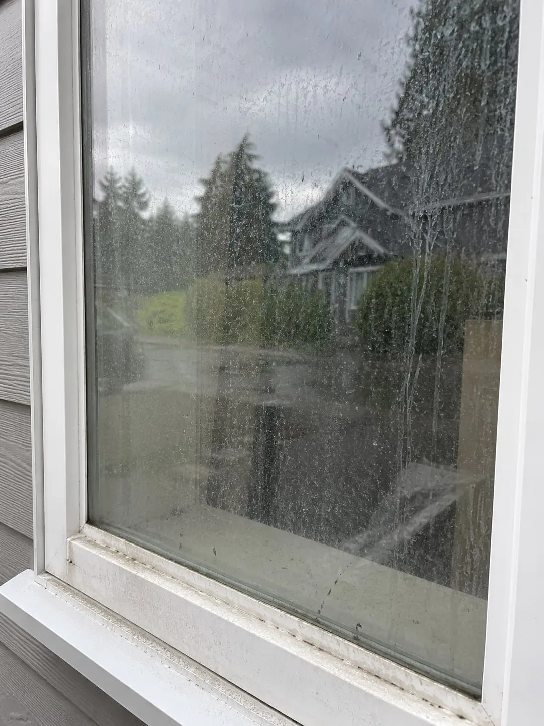 Illustration of a home window covered in water spots and streaks