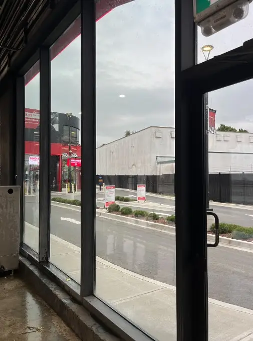 The same storefront windows crystal clear after cleaning, with the street visible outside