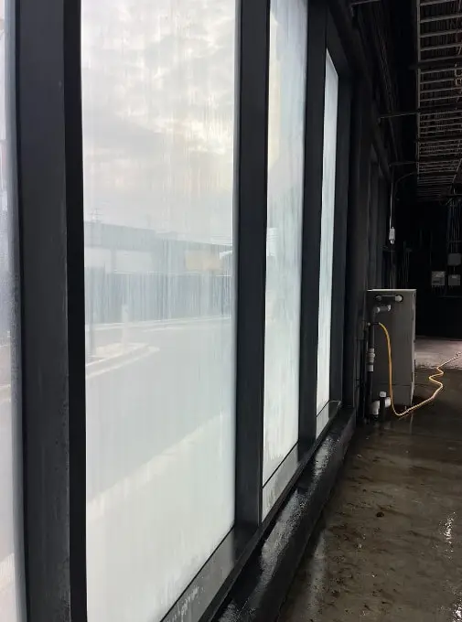 Storefront windows streaked and cloudy before cleaning, seen from inside