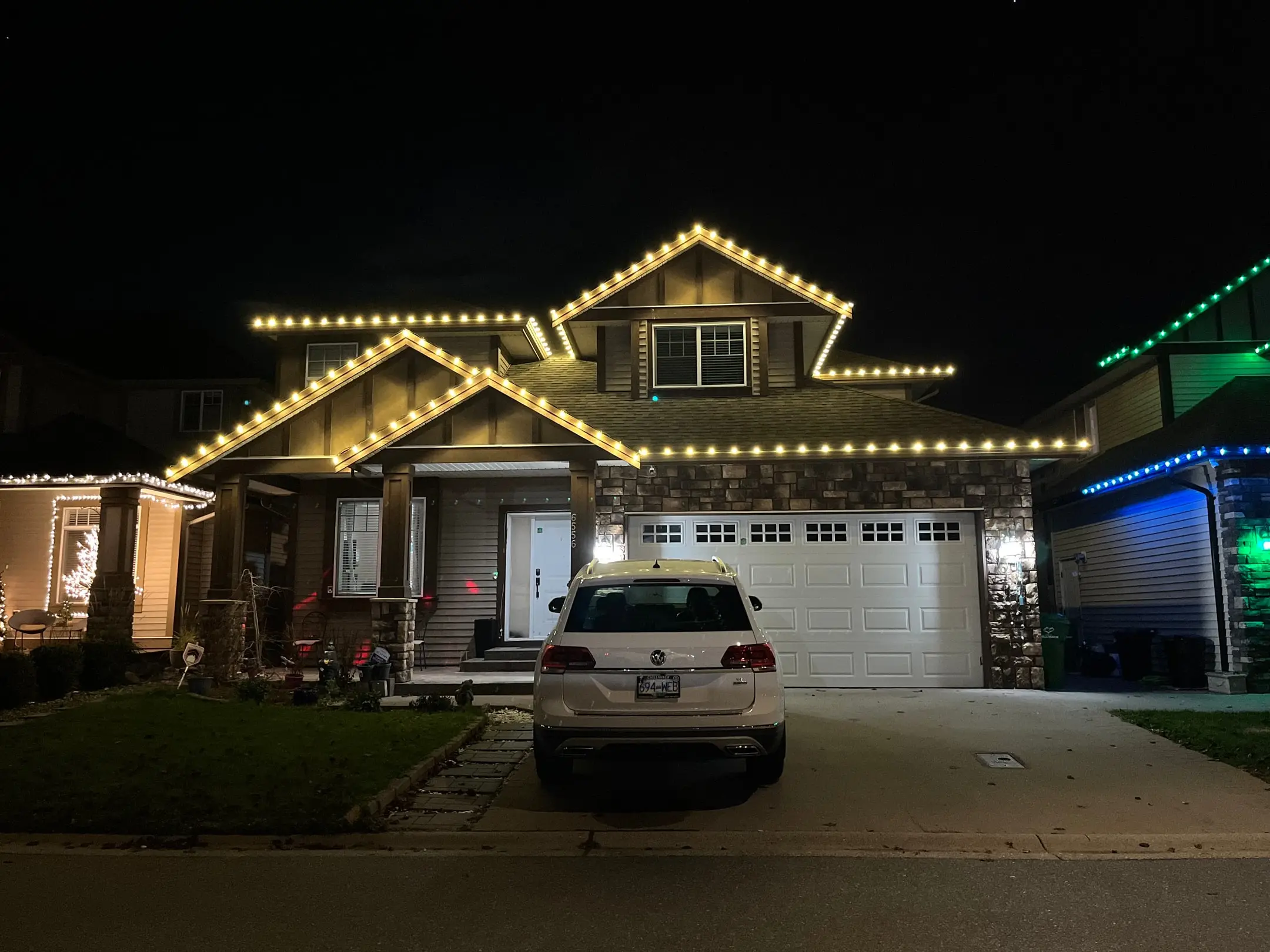 Home decorated with red and green Christmas lights